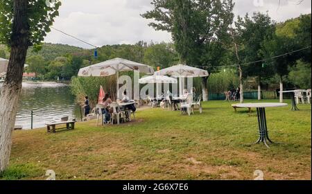 Ankara; Turkey-July 04; 2021: Group of people relaxing on chairs by the lakeside in a beautiful summer day in Lake Eymir in Ankara. Stock Photo