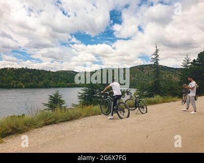 Ankara; Turkey-July 04; 2021: People viewing beautiful view and taking photos on a hill in Lake Eymir in Ankara. People getting used to new normal. Stock Photo