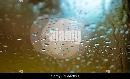 Raindrops on the windshield and car lights The scenery is charming and romantic Ahmed Arnaoty Stock Photo
