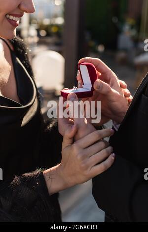 partial view of man making proposal to happy girlfriend outdoors Stock Photo