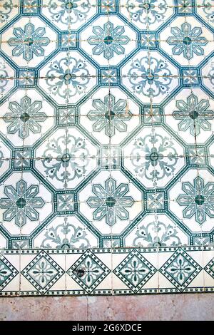 Glazed blue ceramic tiles or azulejos  which cover many buildings in Lisbon, Portugal. These Portuguese tiles have many different geometric designs. Stock Photo
