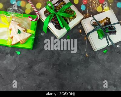 Christmas Gift boxes with set of different dried fruits nuts candied citrus individually wrapped flat lay copy space. Winter holidays celebration. Hea Stock Photo
