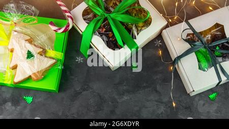 Christmas Gift boxes with set of different dried fruits nuts candied citrus individually wrapped flat lay copy space. Winter holidays celebration. Hea Stock Photo