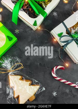 Christmas Gift boxes with set of different dried fruits nuts candied citrus individually wrapped flat lay vertical copy space. Winter holidays celebra Stock Photo