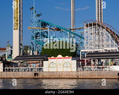 Seafront fairground in Helsinki Sweden with fairground rides overlooking the sea Stock Photo