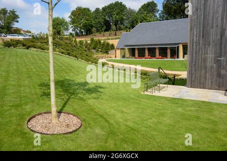 The  beautiful new buildings at the Farmyard Hotel in Somerset, England. This hotel is attached to the exclusive Newt Hotel which is close by. They are owned by Koos and Karen Becker, a billionaire couple from South Africa. He is the CEO of Naspers, a global media company. Stock Photo