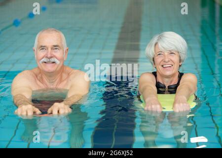elderly couple doing swimming drill exercises Stock Photo