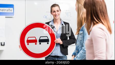 Learner in driving lessons theory explaining traffic situation on white board Stock Photo