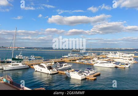 Odessa, Ukraine, October 9, 2012: Parking of yachts and boats in the Black Sea port. There is a blue sky with clouds on the background. Odessa Sea Sta Stock Photo