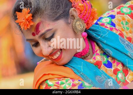 KOLKATA , INDIA - MARCH 12, 2017: Beautiful young girl with spring festive make up with flowers , joyful expression at Holi/Spring festival,known as D Stock Photo