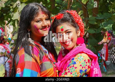 Kolkata, India - March 9th, 2020 : Beautiful young girls with spring festive make up , smiling expression at Holi festival, known as Dol (in Bengali) Stock Photo