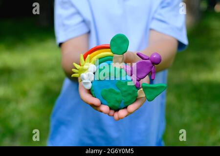 Child Hands Holding Earth Model Clay Rainbow Ecology Concept Top Stock  Photo by ©galiaromaniv88@gmail.com 489952540