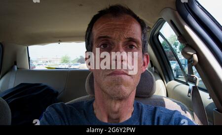 A Middle Aged Male Sitting in a Car Stock Photo