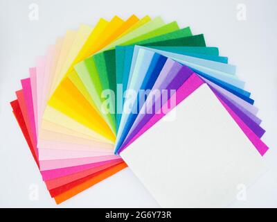 The square pieces of felt spread out by a color spectrum on similarity of a rainbow: from shades of red, pink, yellow, green, blue and bright violette Stock Photo