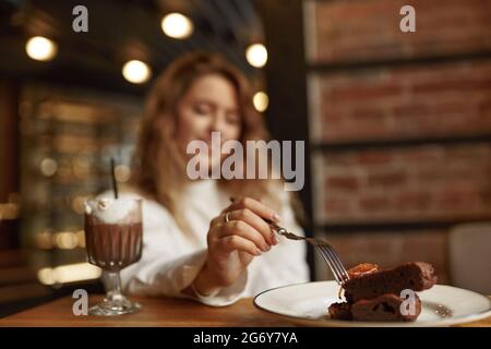 Beautiful woman eating chocolate and drinking coffee Stock Photo