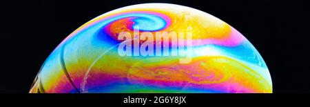 Illustration of a colorful soap bubble half on a black background Stock Photo