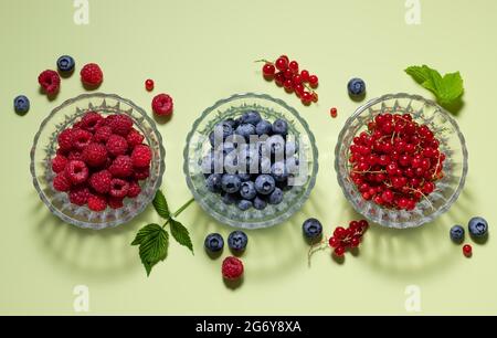 Set of different berries on green background Stock Photo
