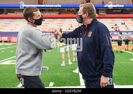 Syracuse, New York, USA. 06th Mar, 2021. Vermont Catamounts head coach Chris Feifs (left) and Syracuse Orange head coach John Desko (right) arm bump prior to an NCAA mens lacrosse game on Saturday, March 6, 2021 at the Carrier Dome in Syracuse, New York. Syracuse won 17-13. Rich Barnes/CSM/Alamy Live News Stock Photo