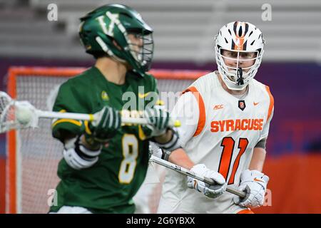 Syracuse, New York, USA. 06th Mar, 2021. Syracuse Orange defenseman Brett Kennedy (11) defends Vermont Catamounts midfielder JJ Levandowski (8) during the first half of an NCAA mens lacrosse game on Saturday, March 6, 2021 at the Carrier Dome in Syracuse, New York. Syracuse won 17-13. Rich Barnes/CSM/Alamy Live News Stock Photo