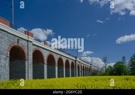 Beautiful scene of viaduct type of bridge surrounded by green fields Stock Photo