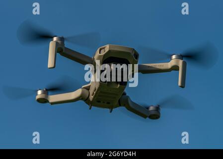 DJI Mavic Mini drone flying Stock Photo