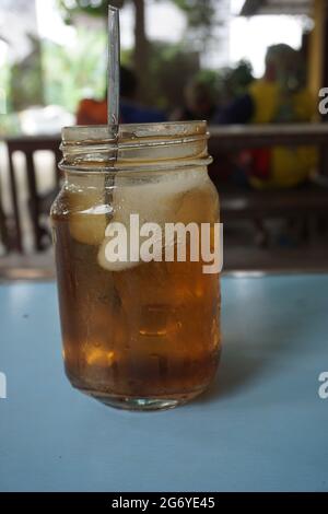 https://l450v.alamy.com/450v/2g6ye45/isolated-sweet-cold-ice-tea-es-teh-with-a-natural-background-famous-drink-in-indonesia-and-easy-to-be-found-everywhere-especially-in-traditional-r-2g6ye45.jpg