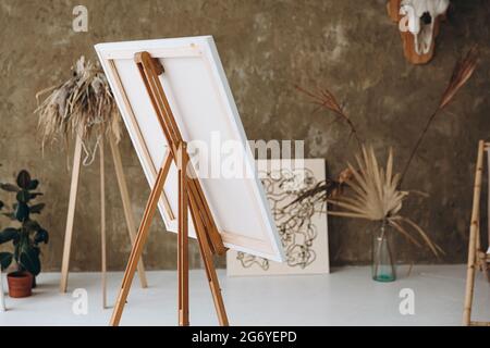 Artist workshop with easel, color palette and brushes Stock Photo