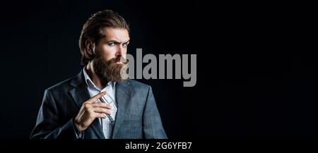 Man perfume, fragrance. Perfume or cologne bottle and perfumery, cosmetics, scent cologne bottle, male holding cologne. Masculine perfume, bearded man Stock Photo
