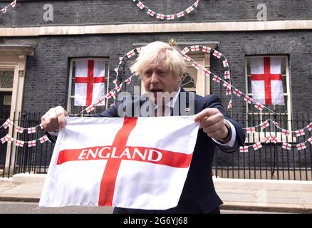London, UK. , . Prime Minister, Boris Johnson holds up an England flag in Downing Street ahead of the Euro 2020 final where England play Italy on Sunday. Credit: Mark Thomas/Alamy Live News Stock Photo