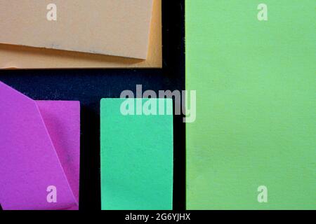 Cardboard of different colors on a dark table with free space for text Stock Photo