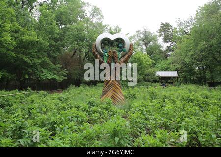 Bentonville Lawrence Plaza Stone Heart in Wooden Hands Sculpture