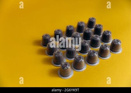Mix of coffee capsules on yellow background Stock Photo