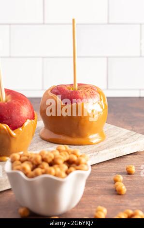 Beautiful Caramel Apples on a Rustic Kitchen Cabinet Ready for Fall Stock Photo