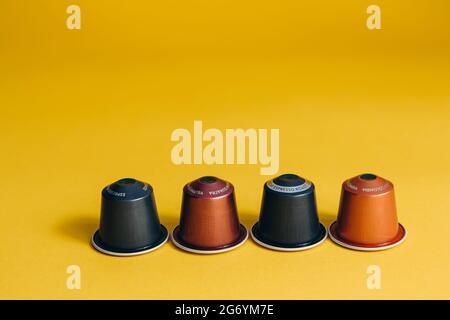 Coffee capsules for coffee machine on yellow background Stock Photo
