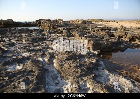 Ruined Sandstone Pool from Hellenistic era on a beach near Phoenician Tel Dor, here were grown sea snails from which the Royalty Purple Dye was made. Stock Photo