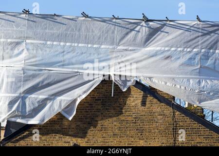 Scaffolding & covering protection on newly completed dormer / dormers / dormas / dorm on the roof on end of terrace Victorian terraced house. UK (124) Stock Photo