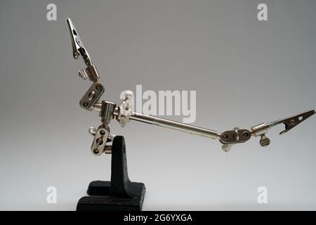 Hand Soldering Iron Stand Clamp isolated on white background with free space for text Stock Photo