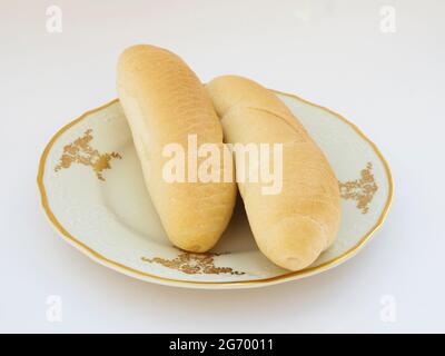 Fresh homemade rolls on porcelain plate on white background, selective focus, photo Stock Photo