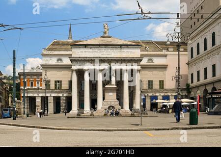 Façade of the Carlo Felice Theatre in the city center with the equestrian statue of Giuseppe Garibaldi and people in summer, Genoa, Liguria, Italy Stock Photo