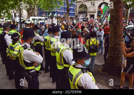 London, UK. 9th July 2021. Protesters and police gather outside the offices of Elbit Systems during the Student Protest For Palestine. Demonstrators marched to various universities in central London demanding they divest from 'all companies complicit in Israeli violations of international law' and that they sever 'all links with complicit Israeli institutions'.  (Credit: Vuk Valcic / Alamy Live News)