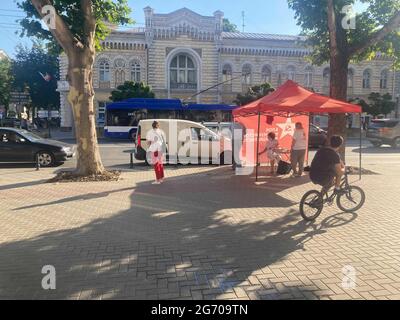 Chisinau, Moldova. 09th July, 2021. People stand in front of a party campaign booth in the Moldovan capital Chisinau. The people of Moldova will elect a new parliament in an early vote on Sunday. Credit: Hannah Wagner/dpa/Alamy Live News Stock Photo