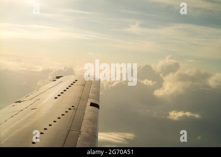 blue sky background with white clouds. Puffy clouds horizon. View from the airplane window on the wing. Stock Photo