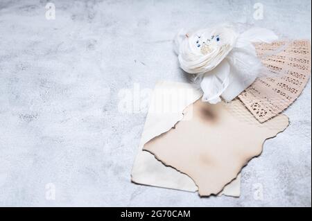Wedding elegant retro hat and old Hand Fan with Empty Blank Paper, on vintage background. Selective focus. copy space. Stock Photo