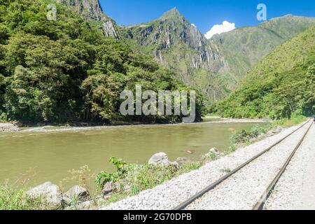 Railway track in Urubamba river valley near Aguas Calientes village, Peru Stock Photo