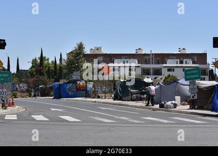 Los Angeles, CA USA - June 30, 2021: Homeless encampment along the entrance to the Hollywood Freeway in Los Angeles Stock Photo