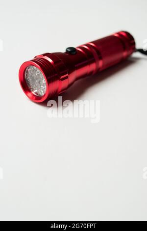 Red bright flashlight with led bulbs on a white background with copy space Stock Photo