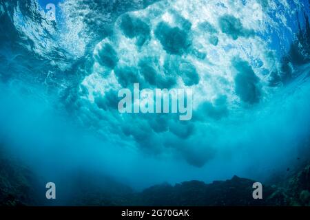 Surf crashes over a shallow reef off the island of Lanai, Hawaii. Stock Photo
