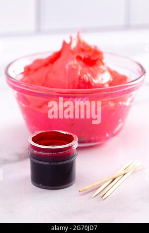 Opened Pot of Gel Food Coloring on a Marble Counter Top Stock Photo