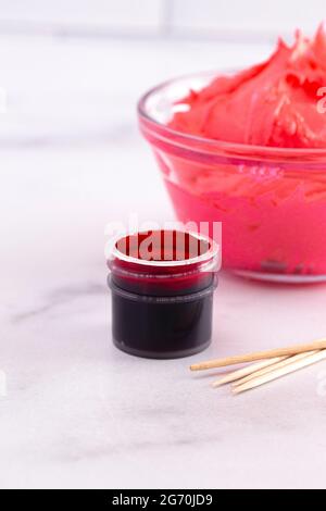 Opened Pot of Gel Food Coloring on a Marble Counter Top Stock Photo