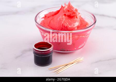 Opened Pot of Gel Food Coloring on a Marble Counter Top Stock Photo